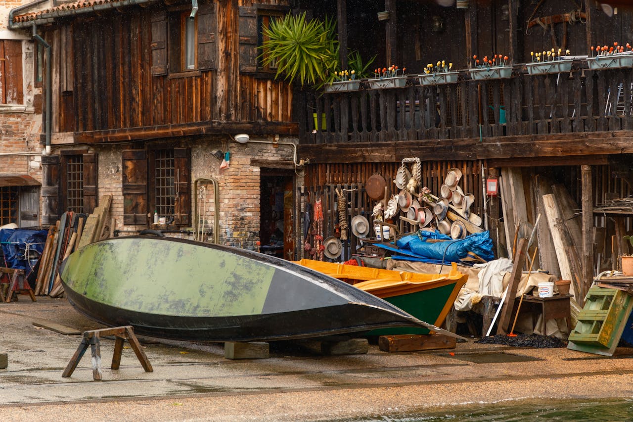 services-04 A classic wooden boat workshop with tools and hats in Venice, Italy.